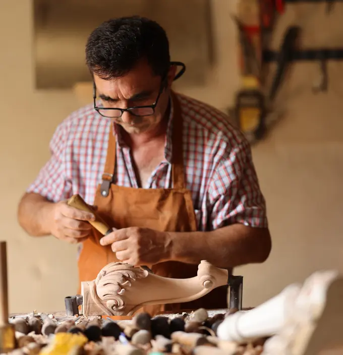 A craftsman works in his woodworking shop.