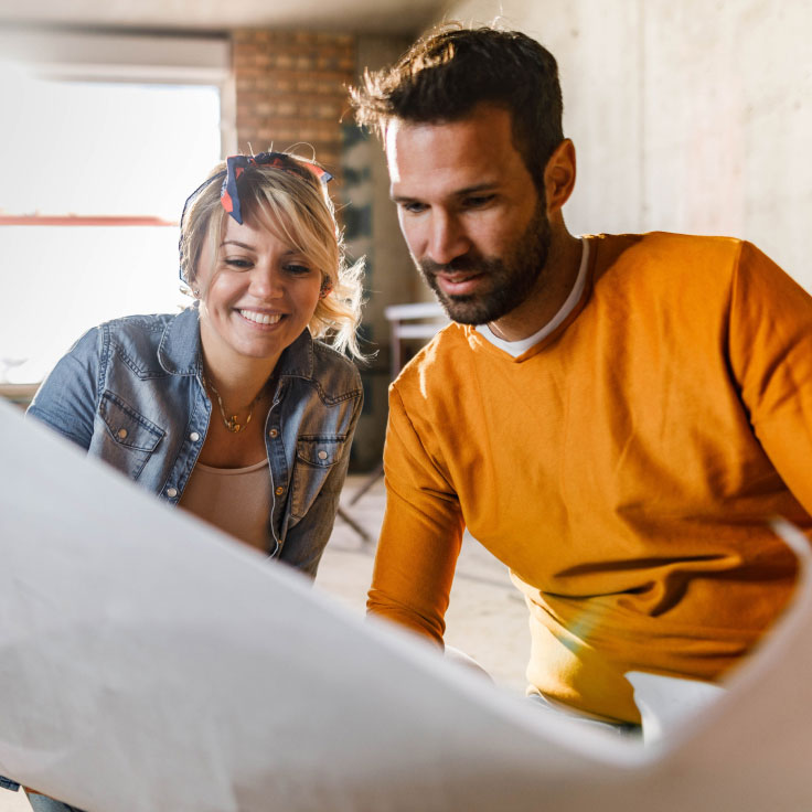 Couple looking at remodeling plans