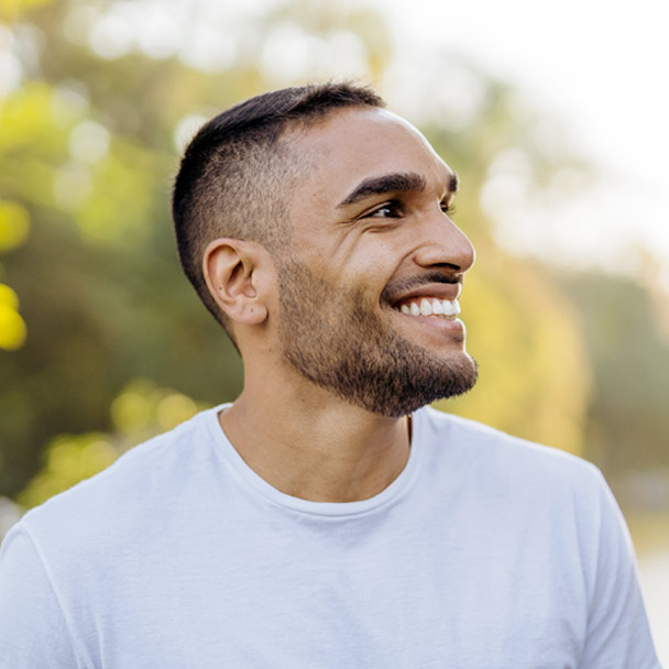 Man smiling and looking off into the distance