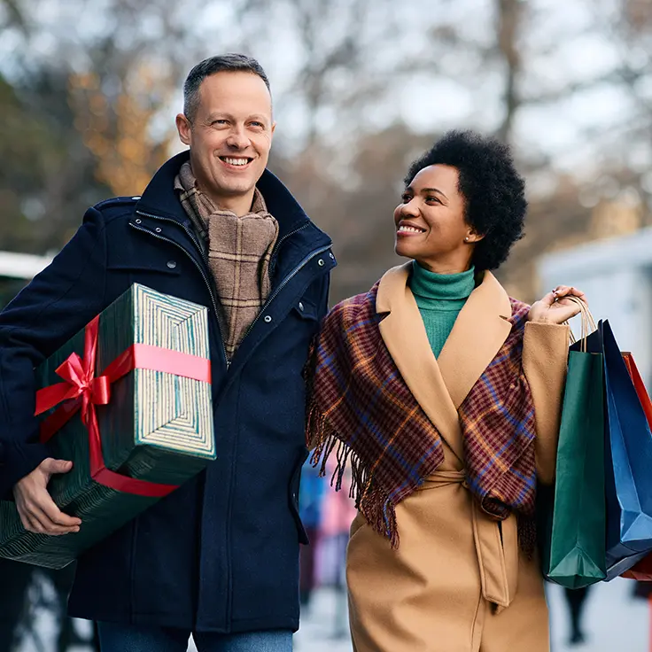 Woman looking through papers while sitting at her laptop