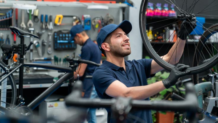 Men working in a bicycle repair shop.