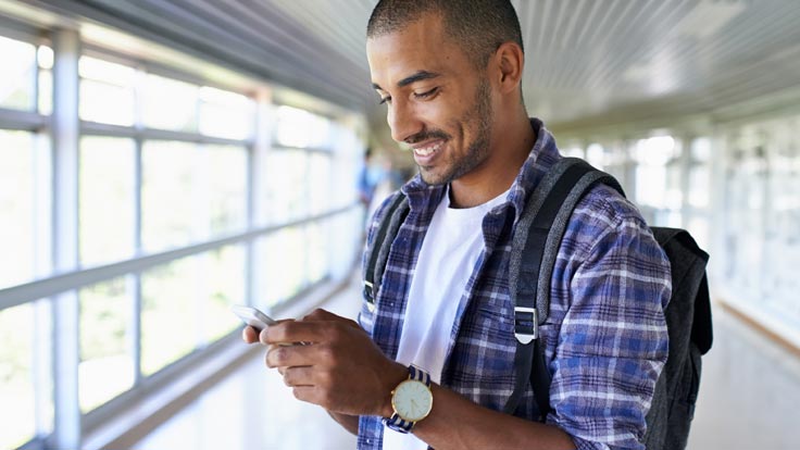 Man checks his mobile phone.