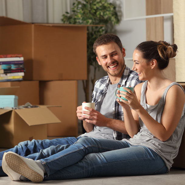 Young couple takes a break from unpacking in their new home.